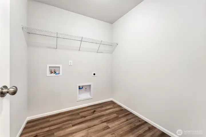 Laundry Room on 2nd floor-Disclaimer- Photos are from a similar floor plan from another community, photos are for illustrative purposes only. Finishes, flooring, features, upgrades, countertops, paint, colors, and other features may vary.