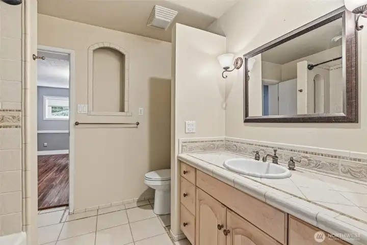 Full bath connected to primary bedroom and living area downstairs