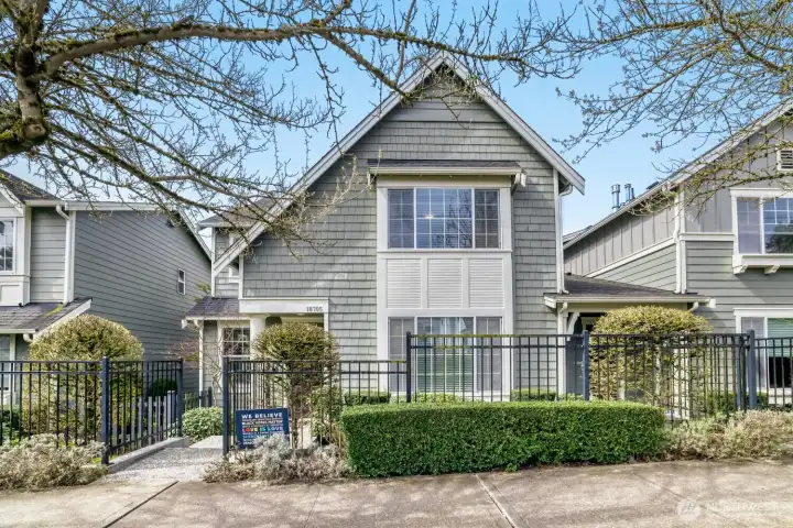 Welcome home to this lovely Craftsman-style townhome with rod-iron gating and manicured landscaping in downtown Bothell!