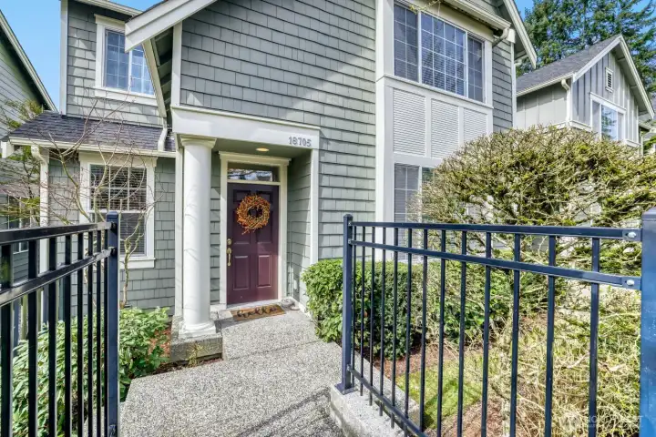 Charming Craftsman townhome with an inviting entrance from the street.
