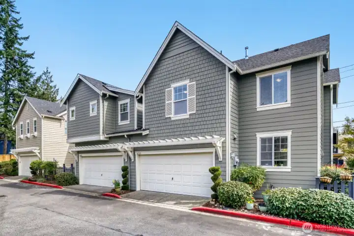 Attractive Craftsman-style townhome with cement planked and cedar shake siding. Exterior recently painted.