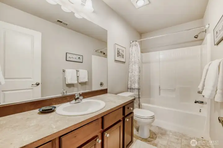 The full second bath is well-lit and will be pleasing to family or guests.