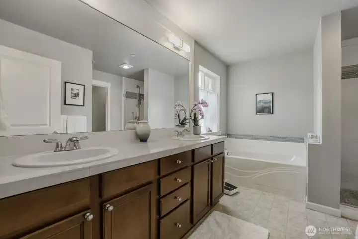 The Primary 5-piece Bath boasts a soaking tub with attractive tile surround and dual sinks with a large vanity.