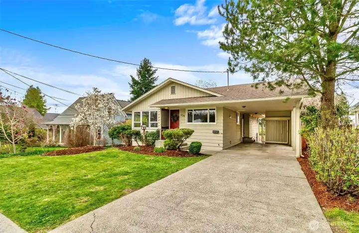 Long concrete driveway with covered carport makes pulling into your home wonderful