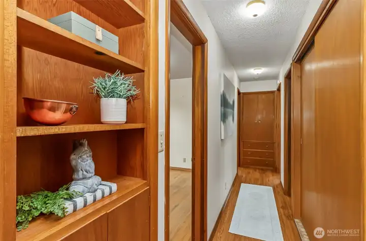 Walking down the hall to the bedrooms, built in shelving and lots of storage space in the hall closets