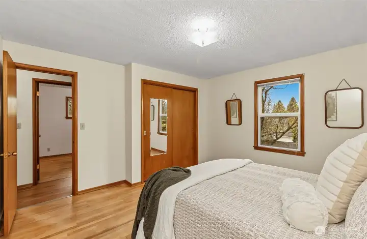 3rd bedroom looking back to the window, closet and hallway. Pretty large bedroom