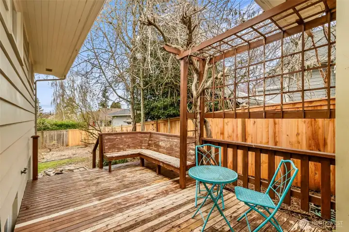 Deck with sitting area off the side door. Excellent place to have your morning coffee. Check out that new fence behind it. Private and Peacefull