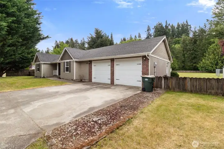 Oversized two-car garage with plenty of room for vehicles, tools, and workshop space. Doors are taller than average also.