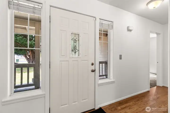 Welcoming entry with hardwood floors and closets on both sides, offering the perfect drop zone for coats, shoes, and everyday storage.
