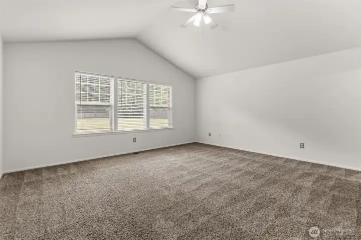 Spacious primary bedroom with serene backyard views and a quiet location at the rear of the home.
