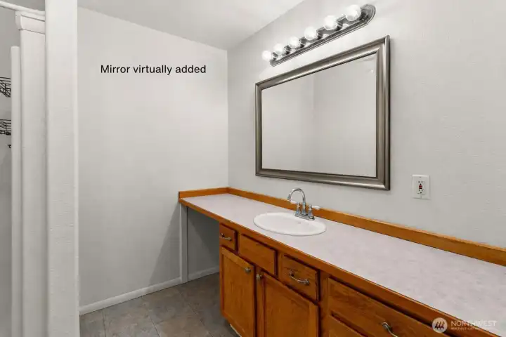 Primary bathroom with virtually added mirror. Primary bathroom with virtually added mirror.