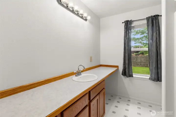 Main hall bath with generous counter space, extra storage, and a functional layout for guests or everyday use.