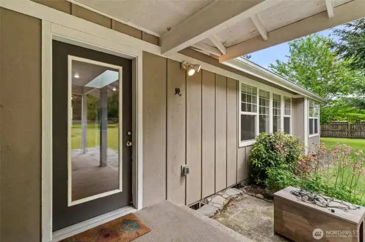 Glass door off the breakfast nook leads directly to the covered back porch while bringing in beautiful natural light.