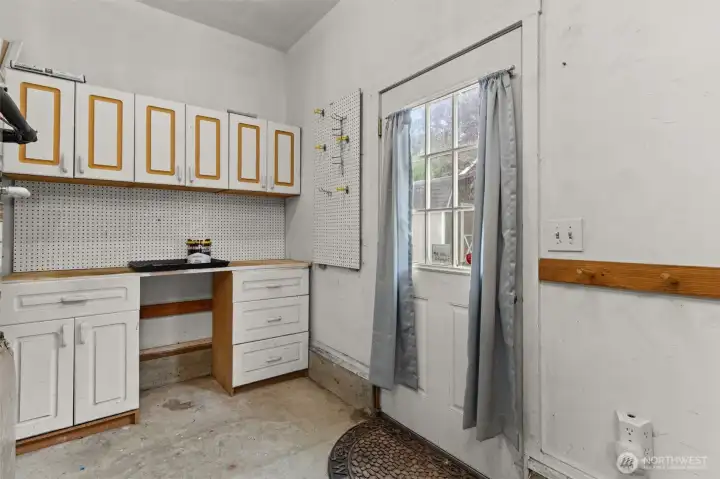 Oversized garage with dedicated workshop space, ideal for hobbies, projects, storage. There is also access to the back yard.