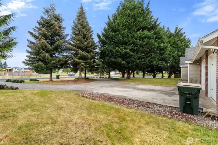Concrete circular driveway provides easy access, additional parking, and convenient guest parking.