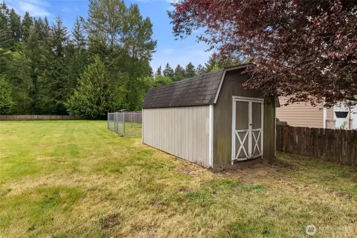 Large storage shed with room for yard tools, gardening supplies, and additional outdoor storage needs.
