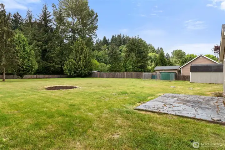Fully fenced backyard offering privacy, room to play, garden, entertain, or simply relax outdoors, complete with a dedicated dog kennel area for pets to safely enjoy the space.