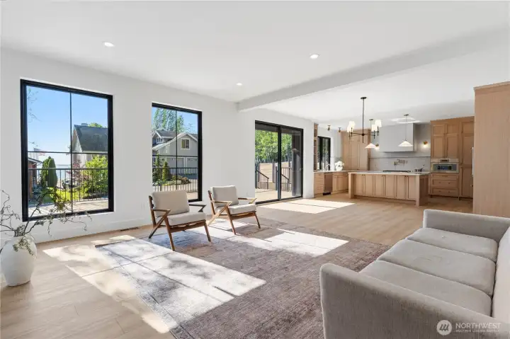 Open-concept great room flows into the kitchen. Sit on the couch and watch the sunset over Semiahmoo and White Rock.