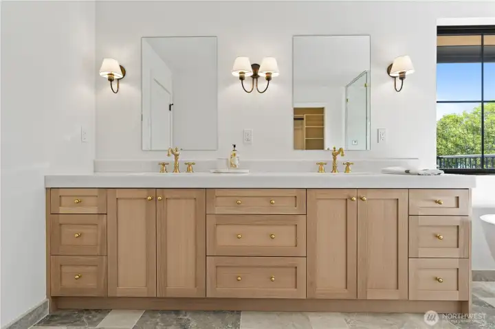 Double vanity with white rift cut oak cabinetry, honed marble counter, and Kingston Brass fixtures.