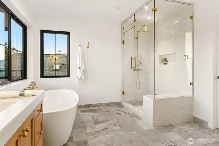 Delta steam shower with zellige-style tile, heated marble bench and floors.