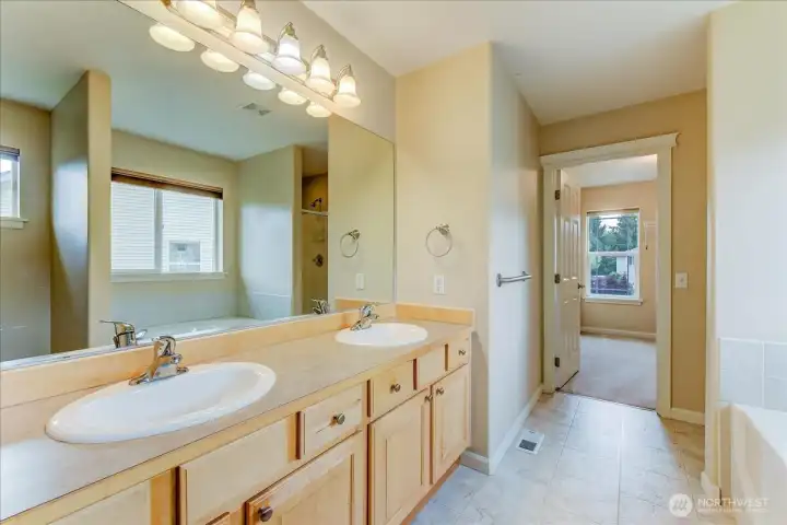 5 piece primary bath looking into the walk-in closet