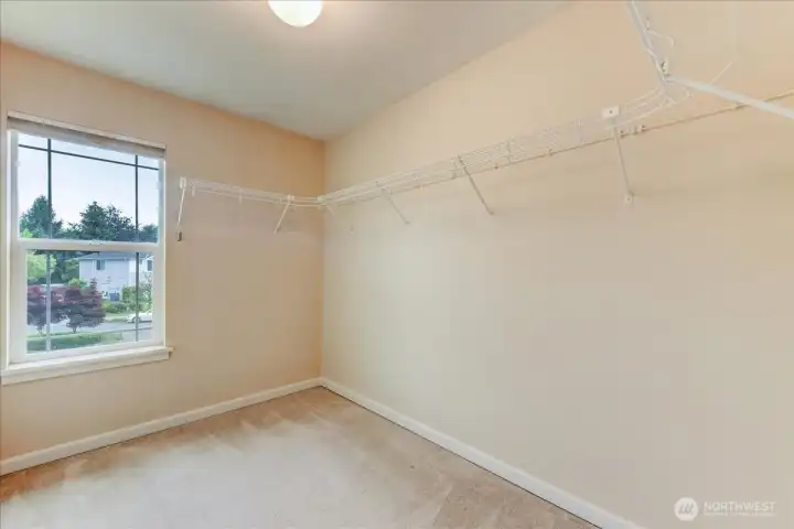 Walk-in closet with window off primary bathroom