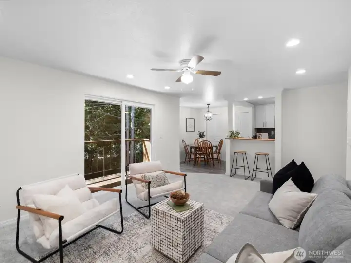 Living Room view of private balcony and dining area/ kitchen