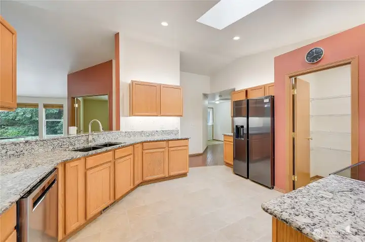 You love this spacious kitchen, with large pantry, granite countertops and spotless appliances.