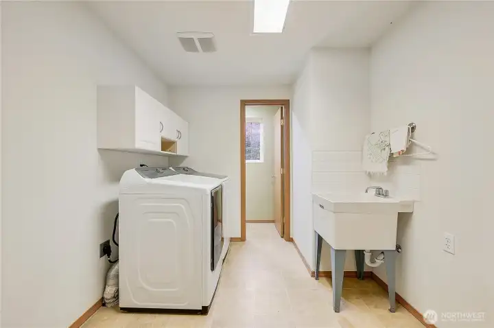 The utility room is spaciouse with plenty of room to add additional storage.
