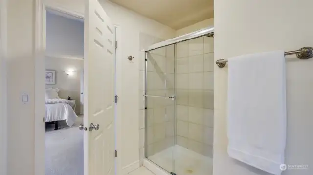 Separate walk-in shower with tile surround.