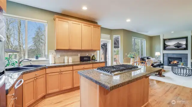 Kitchen flows seamlessly into the Great room featuring shaker-style cabinetry with large center island.