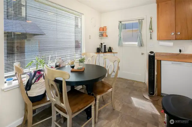 Unit 2220 ~ Kitchen and dining space with an entrance to backyard.