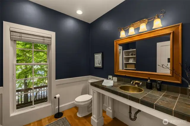 Large powder room with garden view.