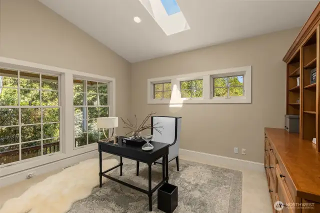 Large den is part of Primary bedroom suite with skylight and garden view.