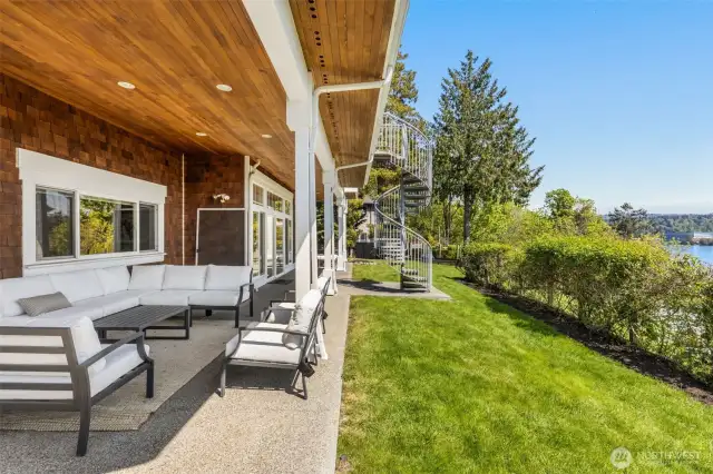 Spacious lower level wrapped around porch with view of Lake Washington, Seahawks training field and mountains.