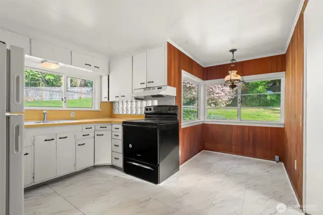 Kitchen with nook looking out onto front yard.