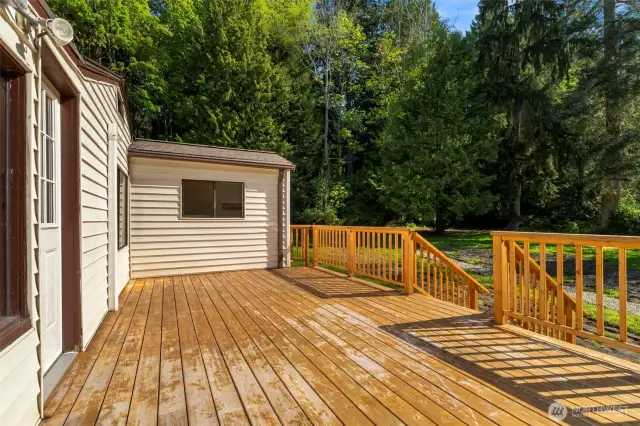Large entertaining deck looking out over the backyard. (2023 new deck).