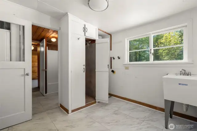 Laundry room with tall utility closet.