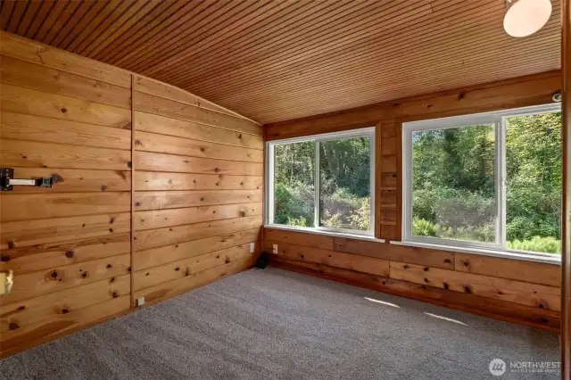 Bedroom with large picture windows looking out onto backyard. Brand new carpet!