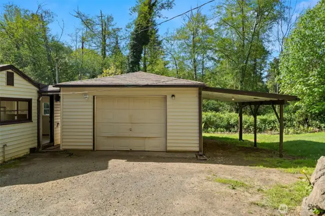 Garage connected by a covered breezeway, plus a carport that offers extra storage for outdoor toys and yard tools.