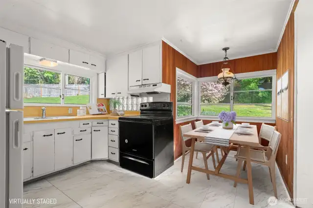 Cozy U-shaped nook near the kitchen—ideal for bench seating or a round pub table.