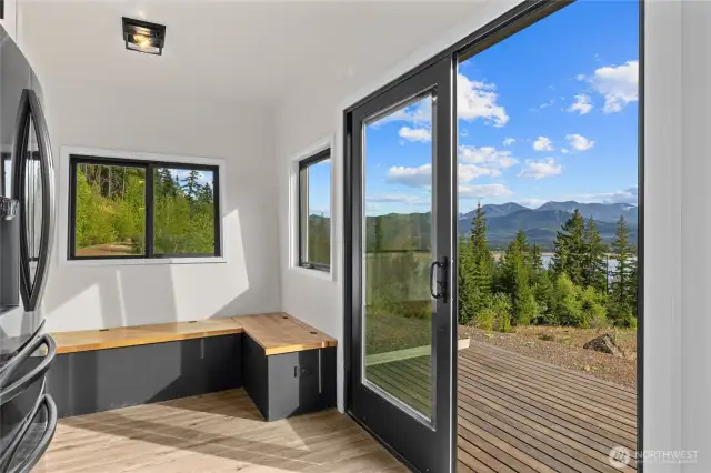 Dining area with built in seating, (great for storage!) Amazing views from the slider onto the front deck.