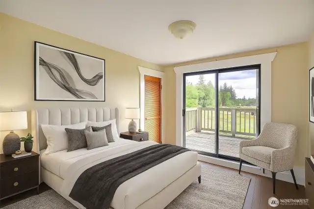 Upstairs bedroom with a walkout deck is virtually staged.