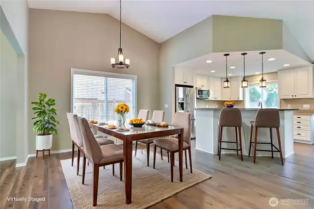As you walk down the entry hall, you will come to your dining room and kitchen. Love the open concept feel here and the patio doors leading to your backyard. ***Virtually Staged***