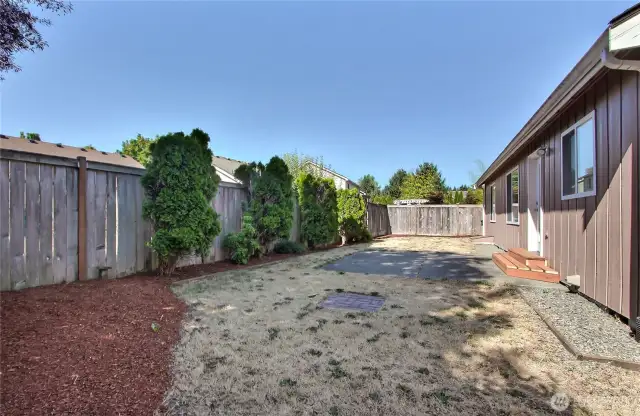 Backyard view, fresh landscaping and new rear stoop. Patio for your set or hot tub. Fully fenced!