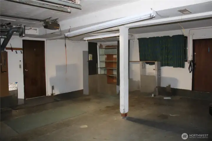 Big Garage door to left enters lower level, door and window on right lead to 2nd garage/workshop