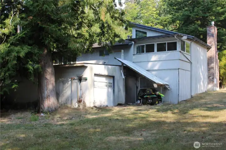 back of house with outdoor access to 2nd garage/workshop