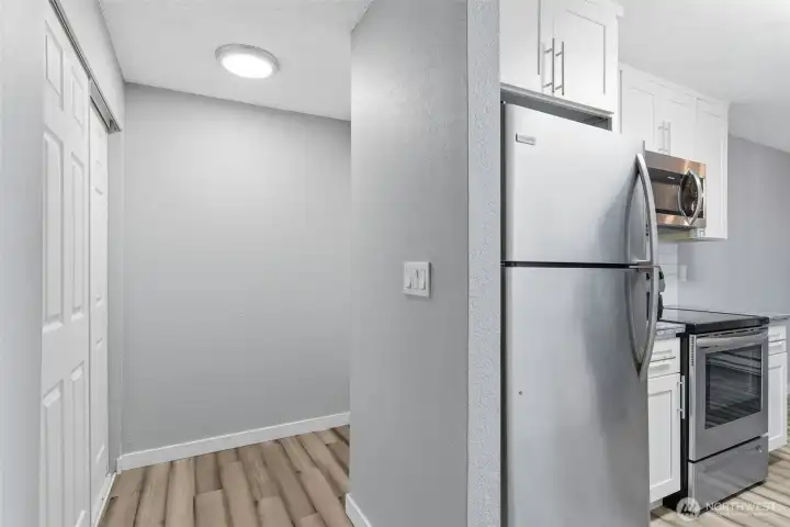 This view shows the entry hallway and coat closet off of the kitchen.