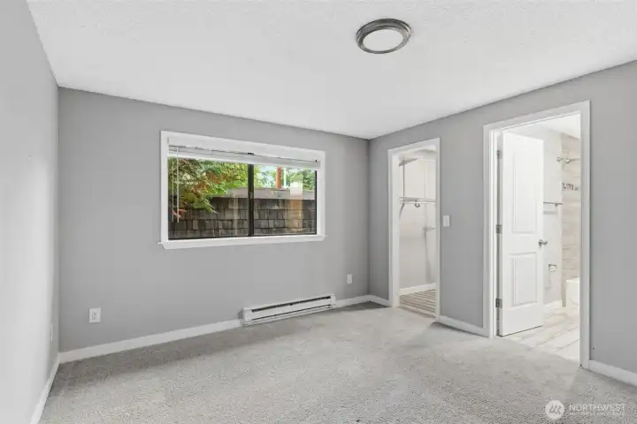 The large primary bedroom offers an en-suite bath and walk-in-closet.