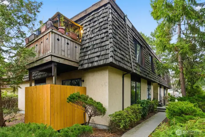 This view shows the unit's back deck and yard.  Come make this yours!